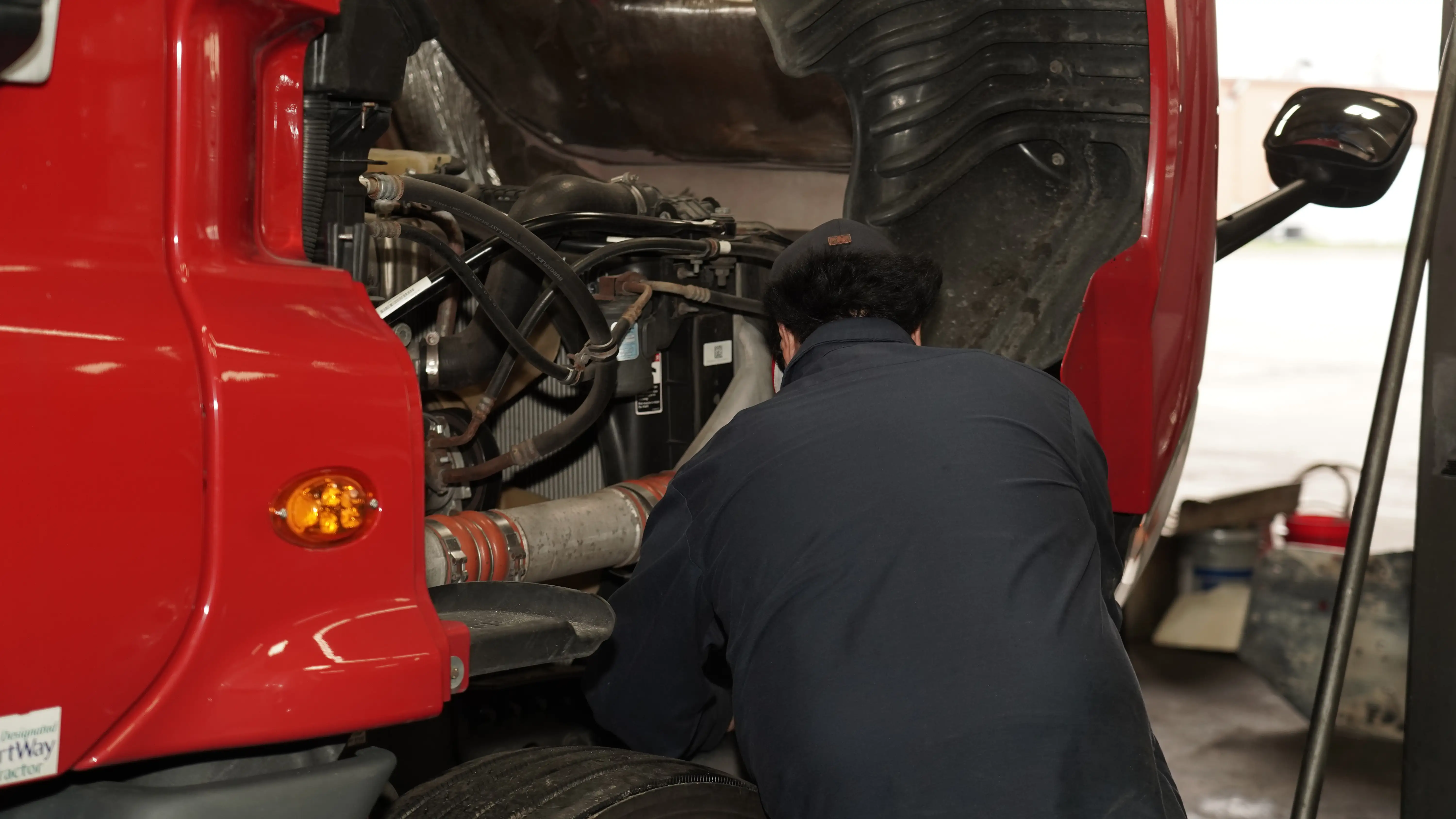 Diesel mechanic performing DOT inspection on semi truck in Savannah, GA